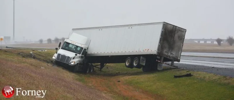 18-wheeler hydroplanes across U.S. Highway 80, jackknifes