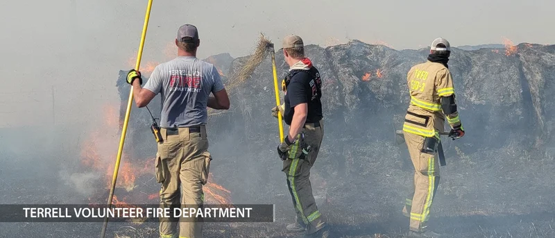 Firefighters working to extinguish more than 100 hay bales ablaze