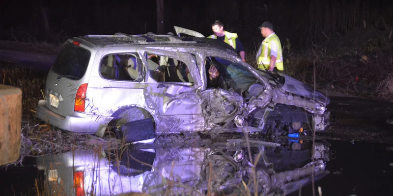 One person injured after driving down highway embankment, striking dumpster, and overturning