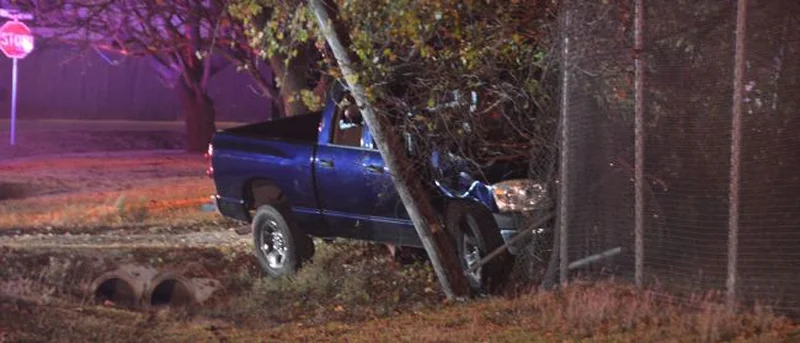 Driver arrested after striking utility pole and fence